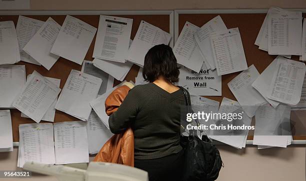 Woman looks over job postings in the New York State Labor Department's Division of Employment Services January 8, 2010 in the Brooklyn borough of New...