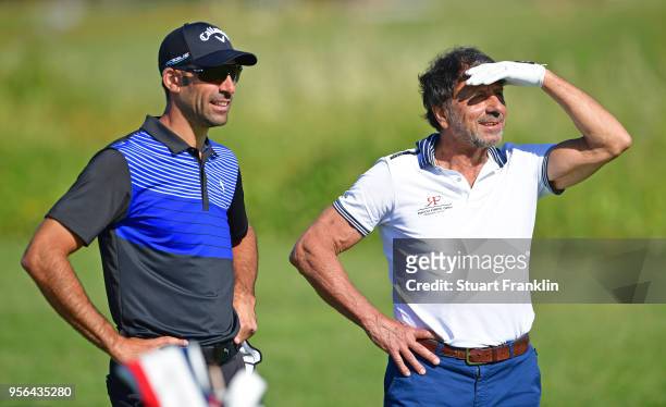 Defending Champion Alvaro Quiros of Spain looks on with Sir Rocco Forte during the pro - am prior to the start of The Rocco Forte Open at the Verdura...