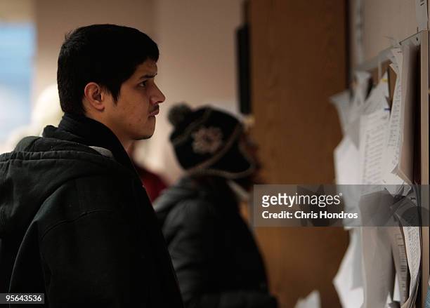 People look over job postings in the New York State Labor Department's Division of Employment Services January 8, 2010 in the Brooklyn borough of New...