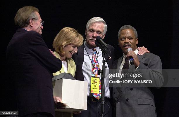 Ted Turner , Time Warner vice chairman/AOL Time Warner vice chairman and founder of CNN accepts a gift from CNN employees Larry King, Judy Woodruff...