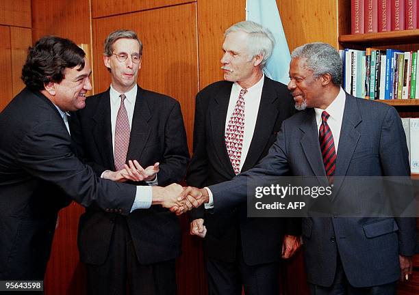 United Nations Secretary General Kofi Annan shakes hands with US Ambassador to the UN Bill Richardson as television mogul Ted Turner and CNN...