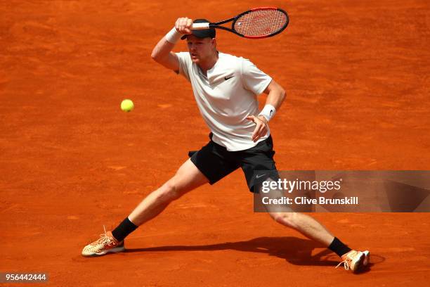 Kyle Edmund of Great Britain in action against Novak Djokovic of Serbia in their second round match during day five of the Mutua Madrid Open at La...