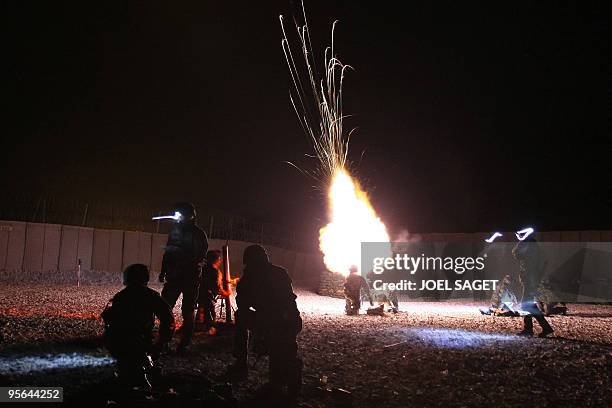 French soldiers of the first company Black rock, 27eme BCA , shoot with a mortar at night at their Forward operating Base Morales-Frazier in Nijrab...