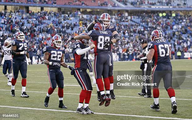 Geoff Hangartner, Lee Evans and Ryan Fitzpatrick of the Buffalo Bills celebrate against the New England Patriots during the game at Ralph Wilson...