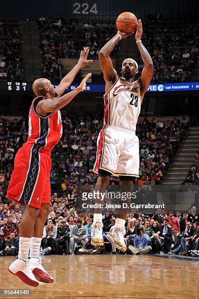 LeBron James of the Cleveland Cavaliers shoots against Trenton Hassell of the New Jersey Nets during the game on January 2, 2010 at the Izod Center...