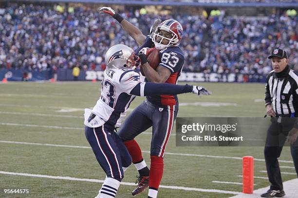 Lee Evans of the Buffalo Bills makes a catch as Leigh Bodden of the New England Patriots defends during the game at Ralph Wilson Stadium on December...