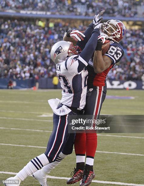 Lee Evans of the Buffalo Bills makes a catch as Leigh Bodden of the New England Patriots defends during the game at Ralph Wilson Stadium on December...