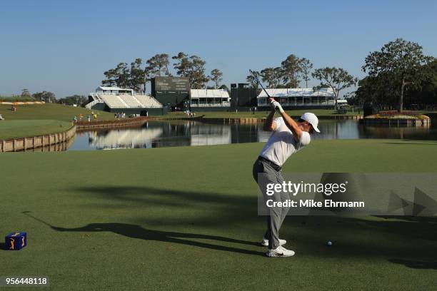 Rory McIlroy of Northern Ireland plays his shot from the 17th tee during practice rounds prior to THE PLAYERS Championship on the Stadium Course at...