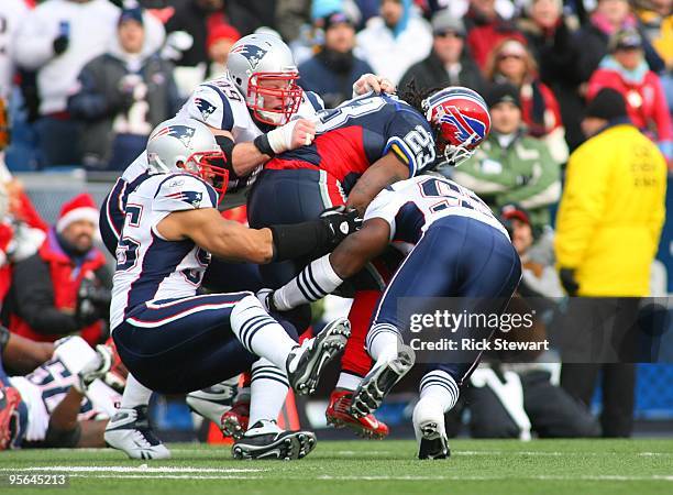 Marshawn Lynch of the Buffalo Bills is taken down by the New England Patriots defense during the game at Ralph Wilson Stadium on December 20, 2009 in...