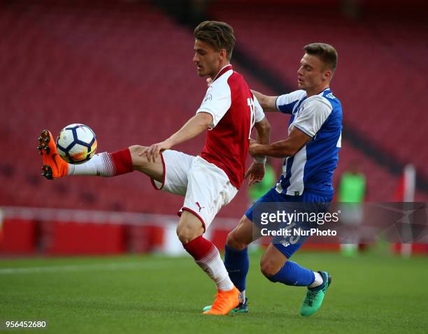 Vlad Dragomir of Arsenal U23s holds of Oleg Reabciuk of Porto FC during Premier League International Cup Final match between Arsenal Under 23 against...
