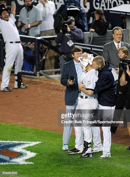 Mark Teixeira of the New York Yankees gets a pie in the face by teammate A.J. Burnett after hitting a walk off home run in the eleventh inning...