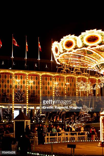 a swing at an amusement park in copenhagen, denmark. - copenhagen christmas stock pictures, royalty-free photos & images
