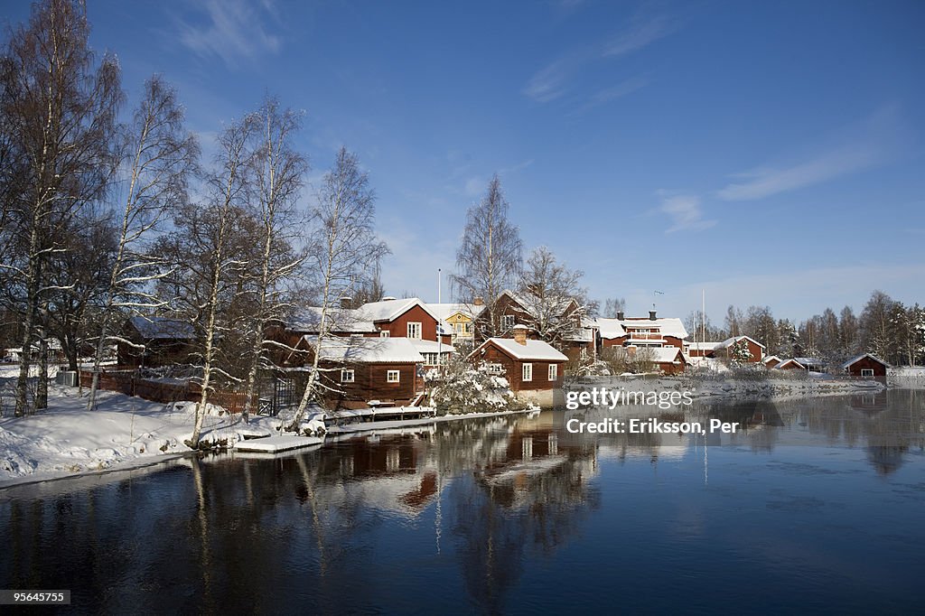 A village by a small river in the winter, Sweden.