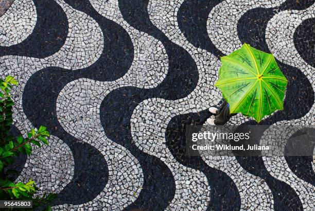 woman standing under an umbrella, brazil. - adoquinado fotografías e imágenes de stock
