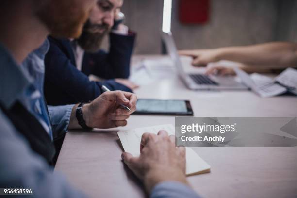 close up of a man taking notes on a business meeting - accounting services stock pictures, royalty-free photos & images