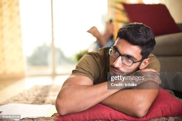 pensive young man - pensive indian man stock pictures, royalty-free photos & images