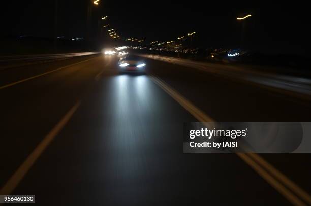 car approaching on the road, at night - röra mot bildbanksfoton och bilder
