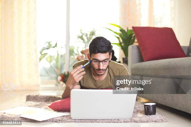 man working in living room - indian economy stock pictures, royalty-free photos & images