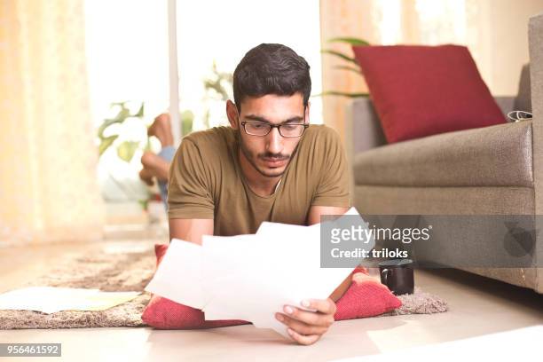man doing paperwork at home - pensive indian man stock pictures, royalty-free photos & images