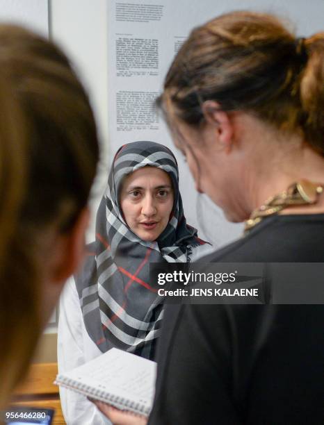 Zeynep Cetin from the Network against Discrimination and Islamophobia talks with journalists on May 9, 2018 at court in Berlin after the court barred...