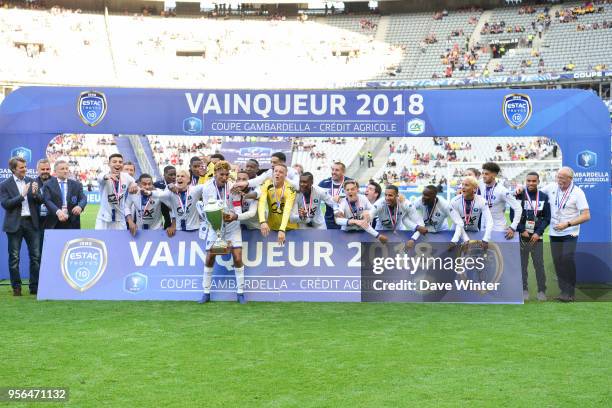 Captain Calvin Bombo of Troyes lifts the trophy as his team celebrate winning the U19 National Cup Final match between Tours and Troyes at Stade de...