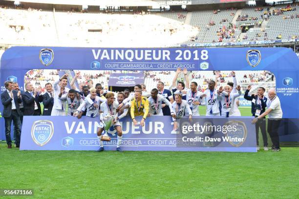 Captain Calvin Bombo of Troyes lifts the trophy as his team celebrate winning the U19 National Cup Final match between Tours and Troyes at Stade de...