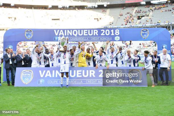 Captain Calvin Bombo of Troyes lifts the trophy as his team celebrate winning the U19 National Cup Final match between Tours and Troyes at Stade de...