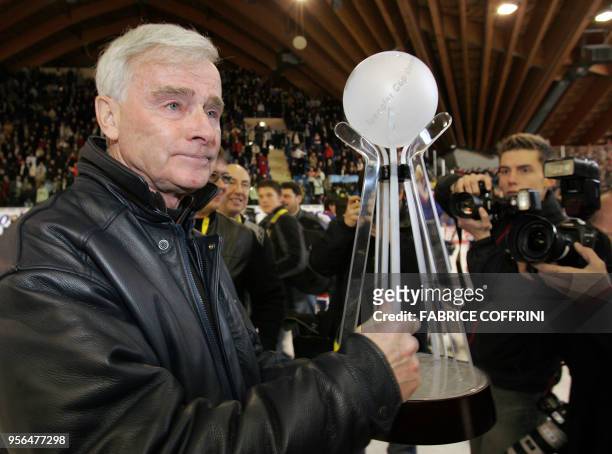 Canadian ice hockey legend and head coach of the Russian team HC Metallurg Magnitogorsk, Dave King hold the trophy 31 December 2005 after his team...