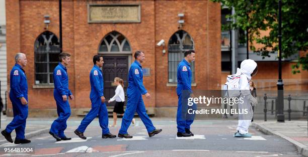 John Phillips, Steve Stranson, Jo Acaba, Tony Antonellis and Lee Archambault, members of the latest crew of the Discovery Space Shuttle walk across a...