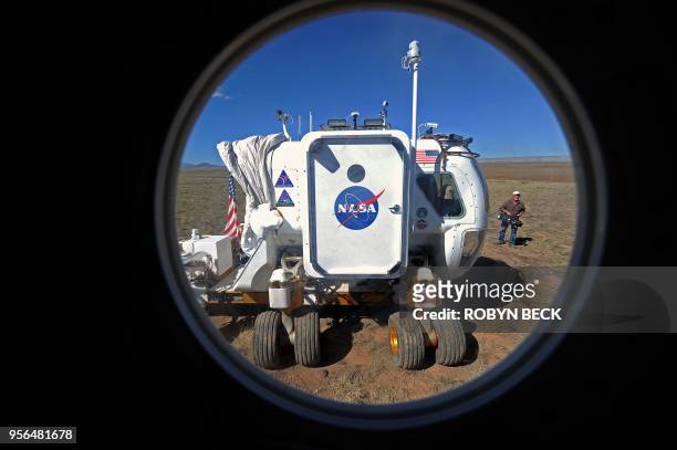 View of one of NASA's Space Exploration Vehicle through the porthole of another SEV as they prepare to dock together, in the northern Arizona desert,...
