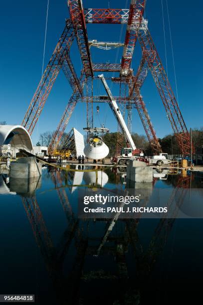 Mock up of the 18,000-pound Orion deep space exporation vehicle is lifted at a high impact pitch of 43-degrees and lifted high enough on the gantry...