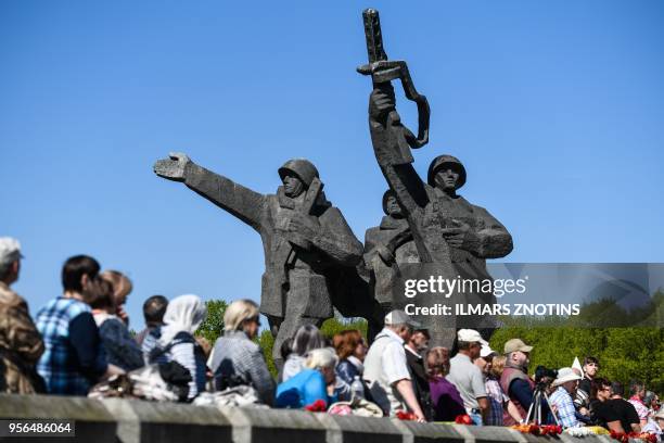 Members of Latvia's large Russian minority gather at the Victory Monument to mark 73 years since the end of World War II and to commemorate the...