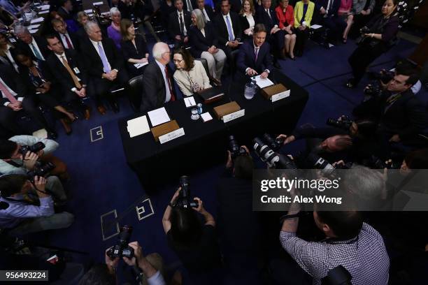 Director nominee Gina Haspel listens to former Sen. Saxby Chambliss as they wait with former Sen. Evan Bayh for the beginning of her confirmation...