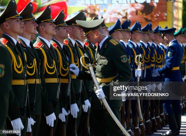 Belarus' honour guards prepare themselves prior to a wreath laying ceremony marking the 73rd anniversary of the victory over Nazi Germany in World...