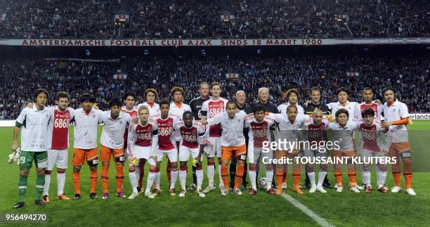 Ajax and the Japanese premier league club Shimizu S-pulse football players pose at the start of the charity match in the Amsterdam Arena April 13,...