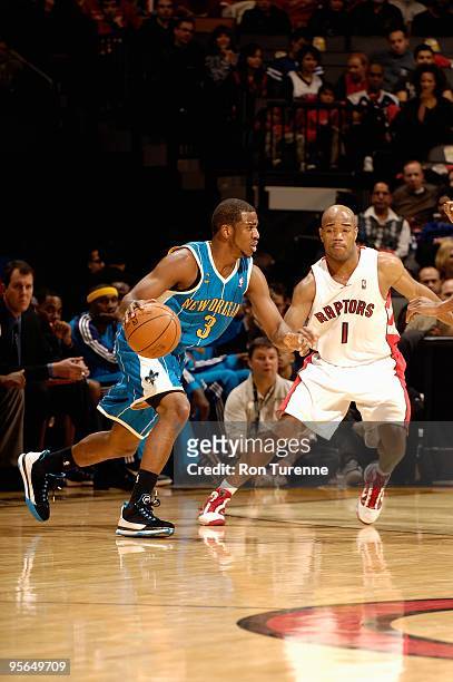 Chris Paul of the New Orleans Hornets drives past Jarrett Jack of the Toronto Raptors during the game on December 20, 2009 at Air Canada Centre in...