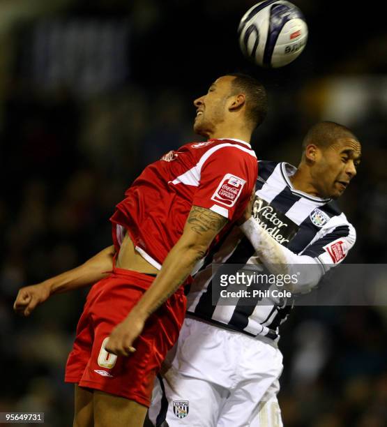 Luke Moore of West Bromwich Albion goes up for the ball against Kelvin Wilson of Nottingham Forest during the Coca-Cola Football League Championship...