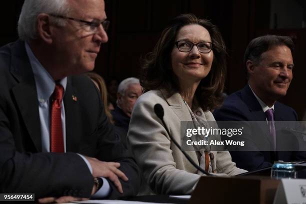 Former Sen. Saxby Chambliss speaks as CIA Director nominee Gina Haspel and former U.S. Sen. Evan Bayh listen during her confirmation hearing before...