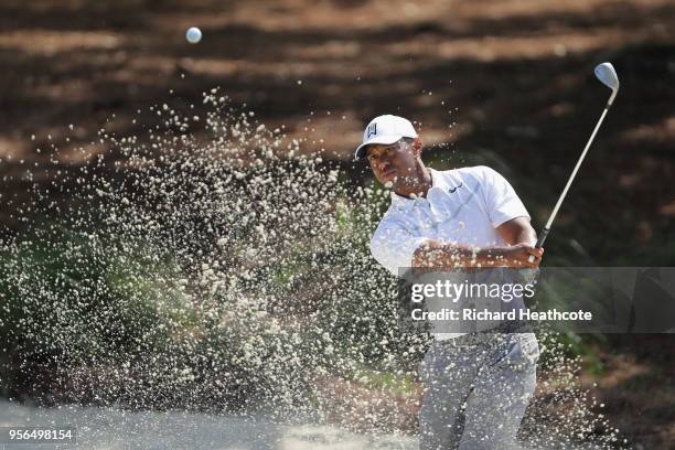 Tiger Woods of the United States plays a shot from a bunker during practice rounds prior to THE PLAYERS Championship on the Stadium Course at TPC...