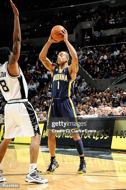Dahntay Jones of the Indiana Pacers looks for an open pass over Roger Mason Jr. #8 of the San Antonio Spurs during the game on December 19, 2009 at...