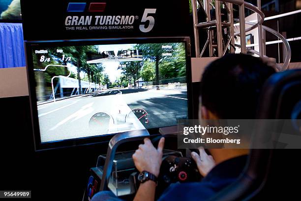 An attendee plays Gran Turismo on Sony Corp.'s Playstation 3 during the 2010 International Consumer Electronics Show in Las Vegas, Nevada, U.S., on...