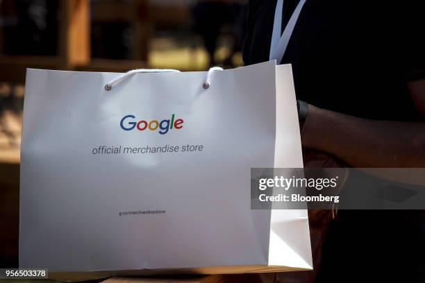 An attendee holds a shopping bag during the Google I/O Developers Conference in Mountain View, California, U.S., on Tuesday, May 8, 2018. Each year,...