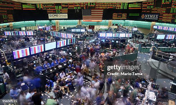 Traders work in the crude oil options pit moments before the closing bell at the New York Mercantile Exchange January 8, 2010 in New York City. Crude...