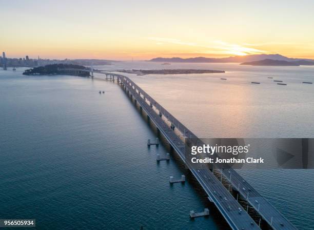 aerial over traffic bay bridge at sunset, san francisco, usa - jonathan clark stock pictures, royalty-free photos & images