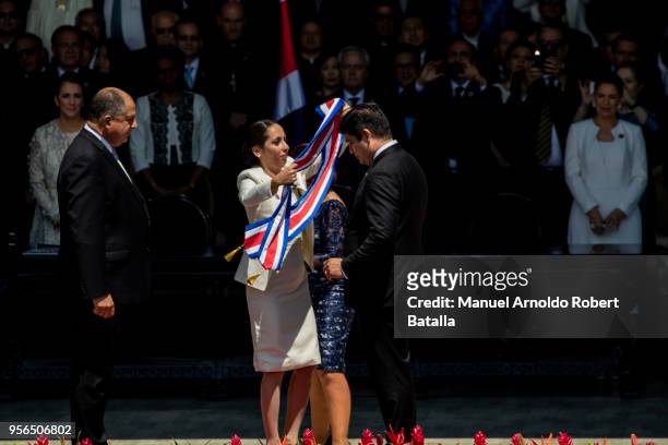 Outgoing President Luis Guillermo Solis looks on while Carolina Hidalgo President of the Congress gives newly elected President of Costa Rica Carlos...