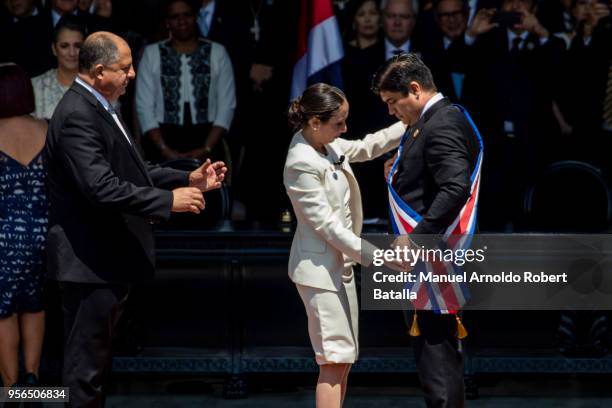 Outgoing President Luis Guillermo Solis looks on while Carolina Hidalgo President of the Congress gives newly elected President of Costa Rica Carlos...