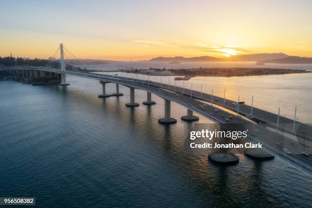 aerial over traffic bay bridge at sunset, san francisco, usa - jonathan clark stock pictures, royalty-free photos & images