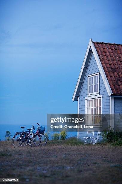 bicycles by a house, sweden. - cottage water stock pictures, royalty-free photos & images