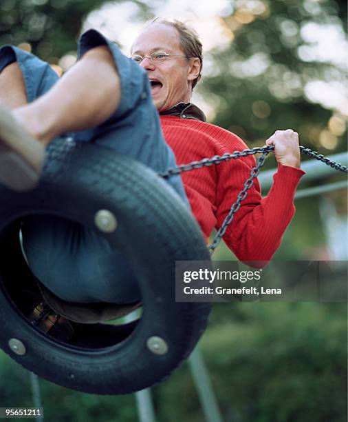 a man on a swing, sweden. - lena spoof stock pictures, royalty-free photos & images