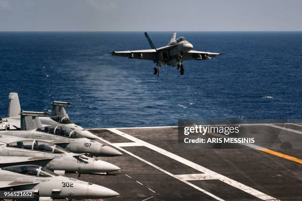 An F18 Hornet fighter jet lands on the 330 meters navy aircraft carrier USS Harry S. Truman in the eastern Mediterranean Sea on May 8, 2018. - The...